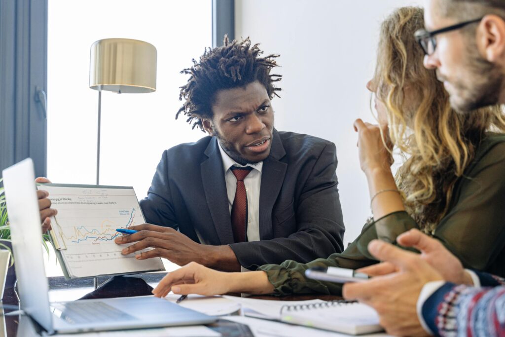 Business professionals discussing financial data during a collaborative meeting.